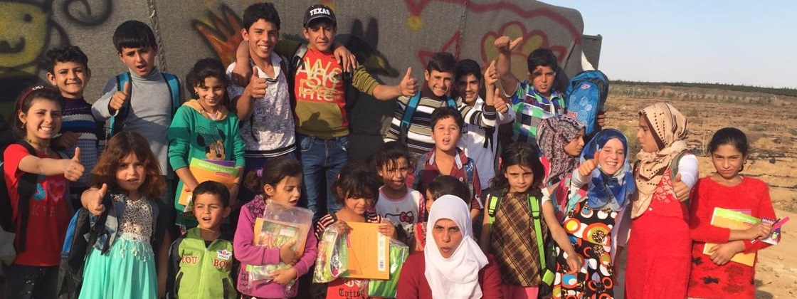 children in front of school tent